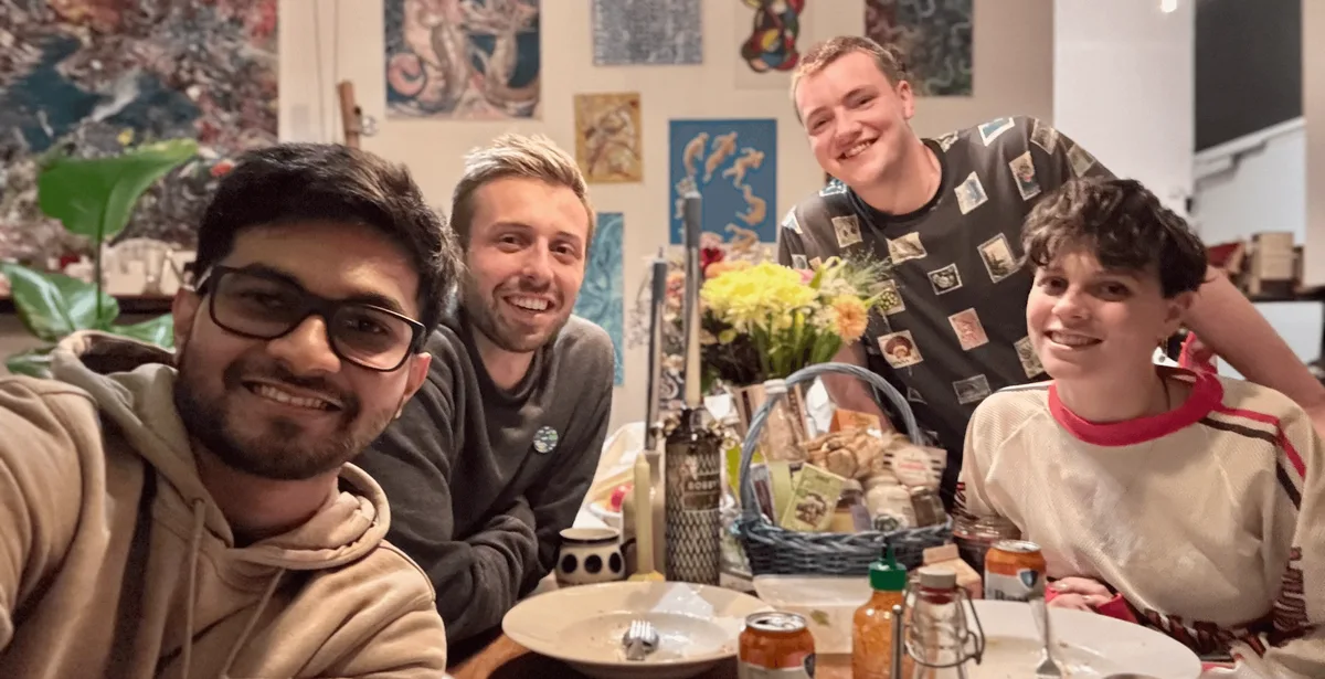 The team squeezed around a dinner table.